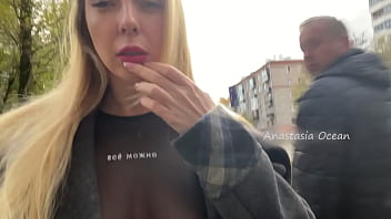 A gal demonstrates her bra-stuffers while ambling in public in the city